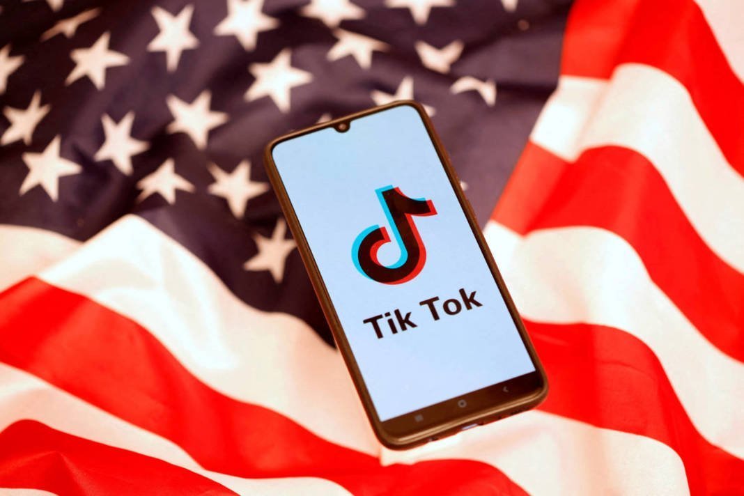 File Photo: Tiktok Logo Is Displayed On The Smartphone While Standing On The U.s. Flag In This Illustration