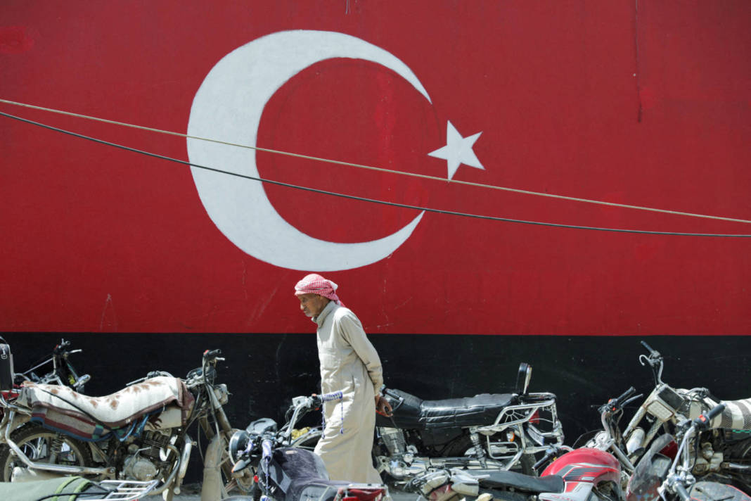 A Man Walks Past A Wall Painted With The Turkish Flag In The Rebel Held City Of Azaz