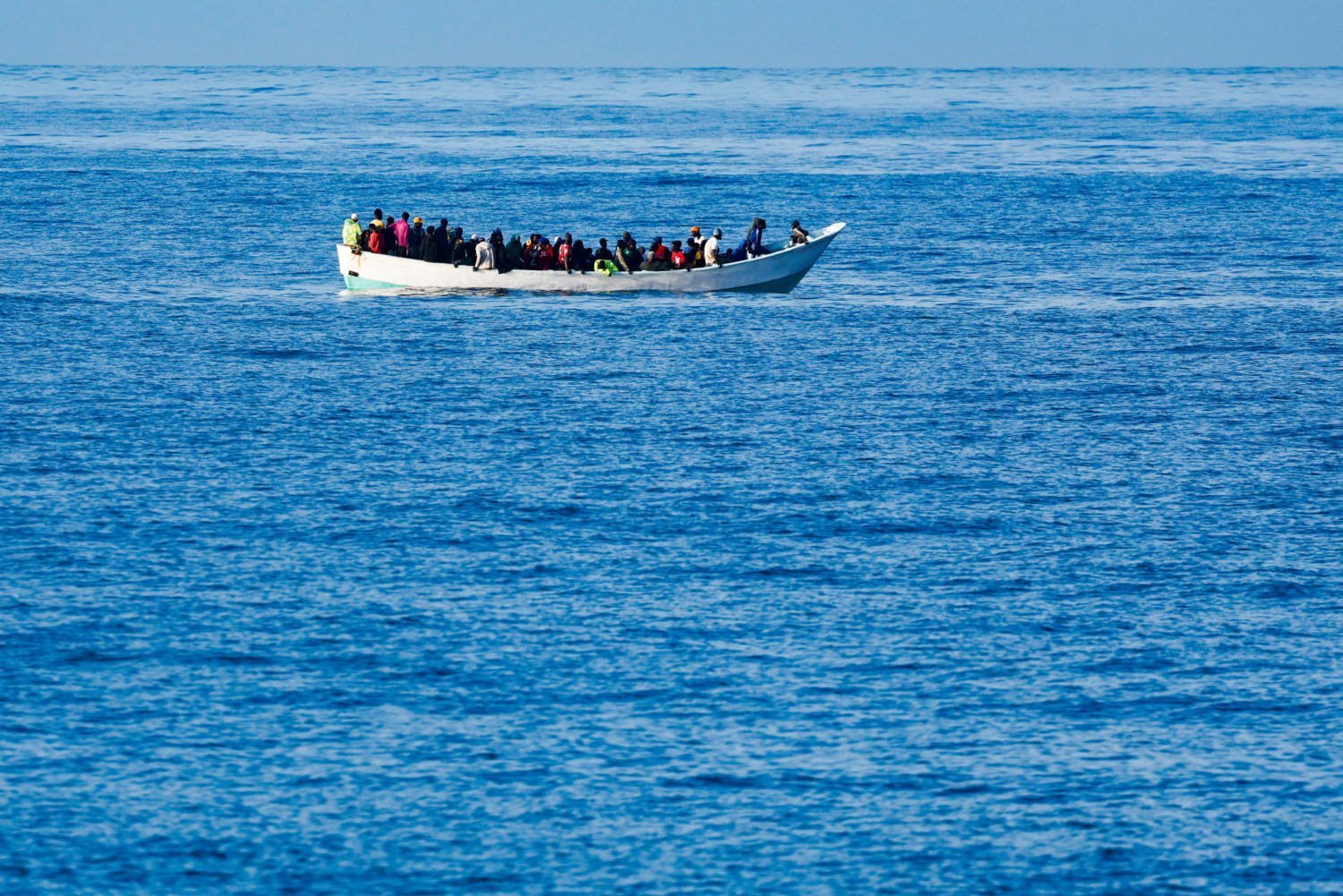 Wooden Boat Carrying Migrants Waits To Be Rescued By A Spanish Coast Guard Vessel, Near Bahia Feliz Beach