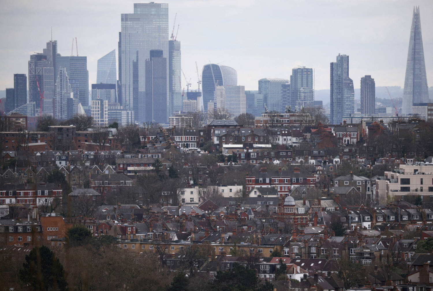 File Photo: Rows Of Houses Lie In Front Of The City Of London Skyline In London