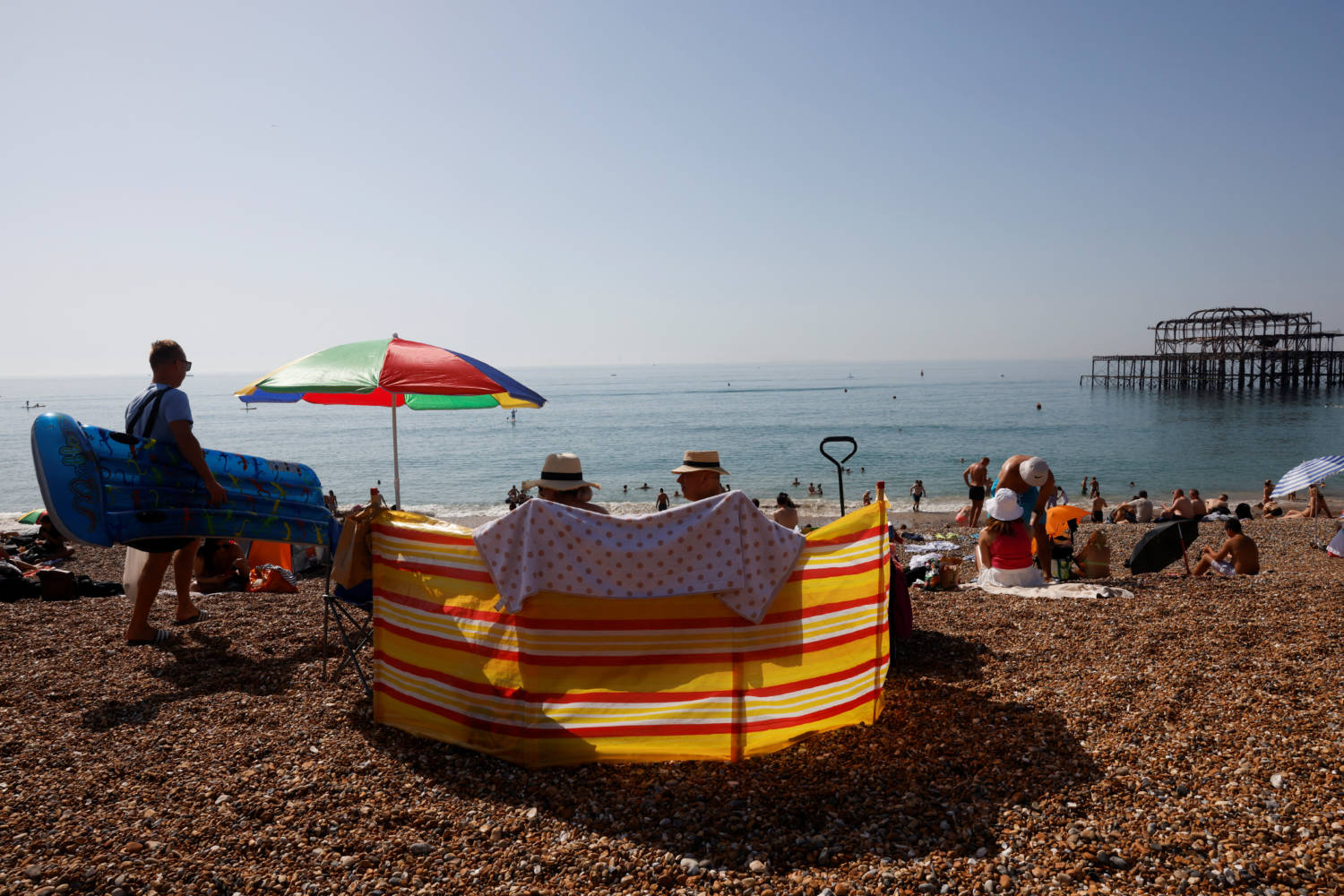People Enjoy The Beach During Hot Weather In Brighton