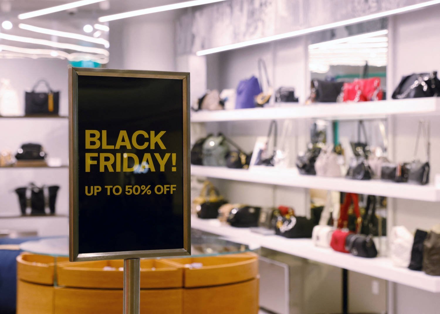 A Black Friday Sign Stands Outside A Hand Bag Store In Singapore