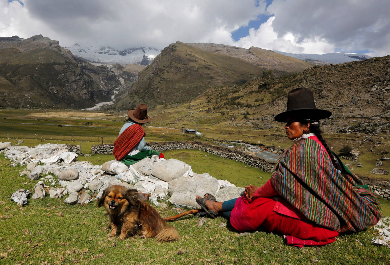 File Photo: Shepherdess And Her Daughter Rest In Front Of Hualcan Glacier In Huascaran Natural Reserve In Ancash
