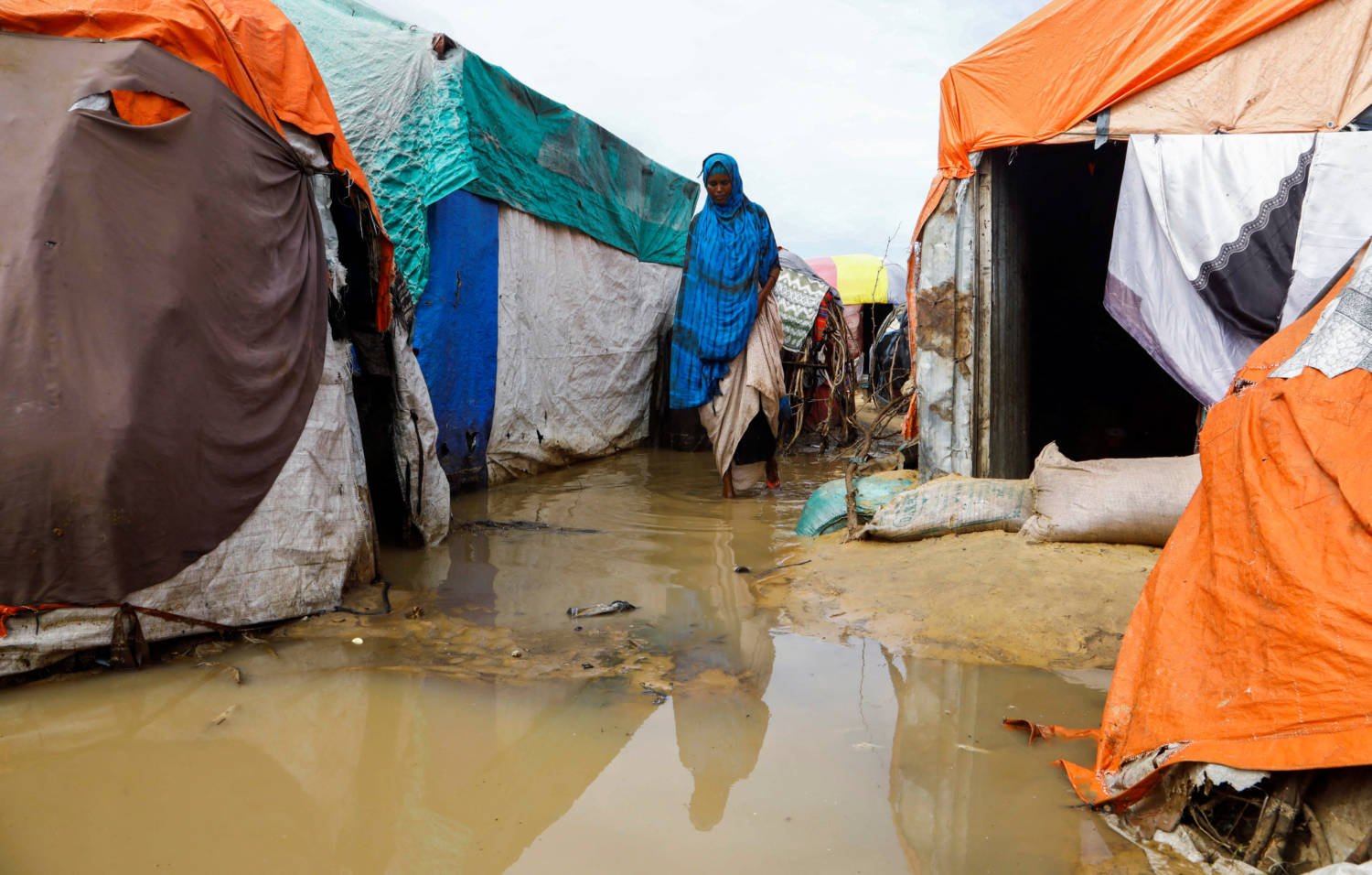 A Somali Woman Walks Within Their Makeshift Shelters At The Al Hidaya Camp For The Internally Displaced People Following Heavy Rains In The Outskirts Of Mogadishu