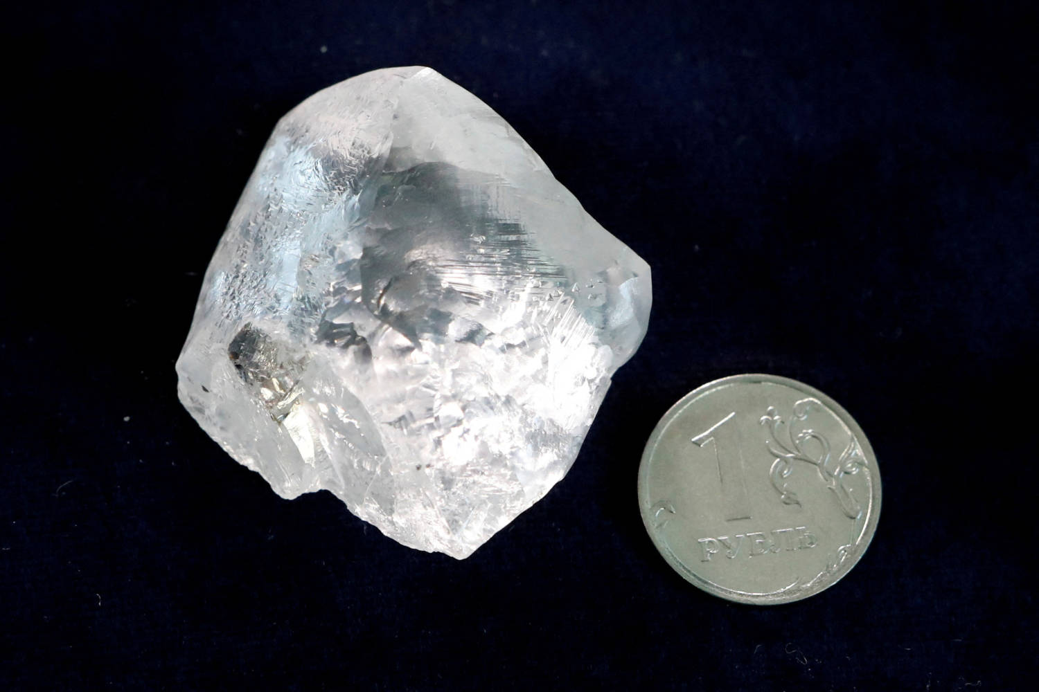 File Photo: A Rough Diamond Is Seen Next To A One Rouble Coin At The Polishing Affiliate Of Russian Diamond Producer Alrosa In Moscow, Russia