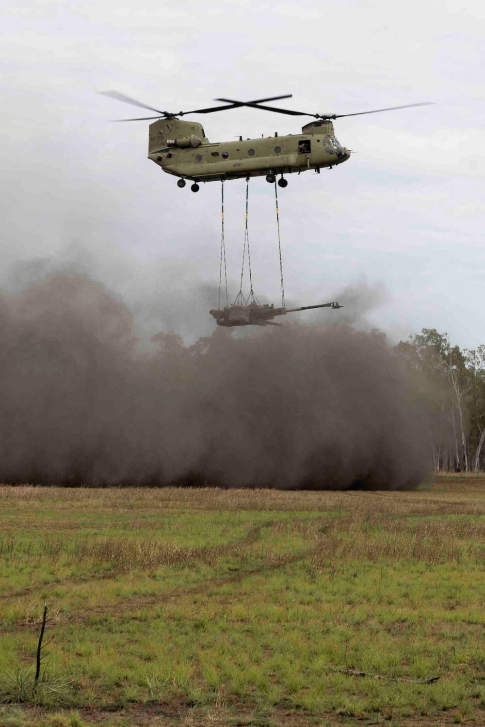 Australian Army Service Members Utilize A Ch 47 Chinook Helicopter To Deploy An Artillery Cannon
