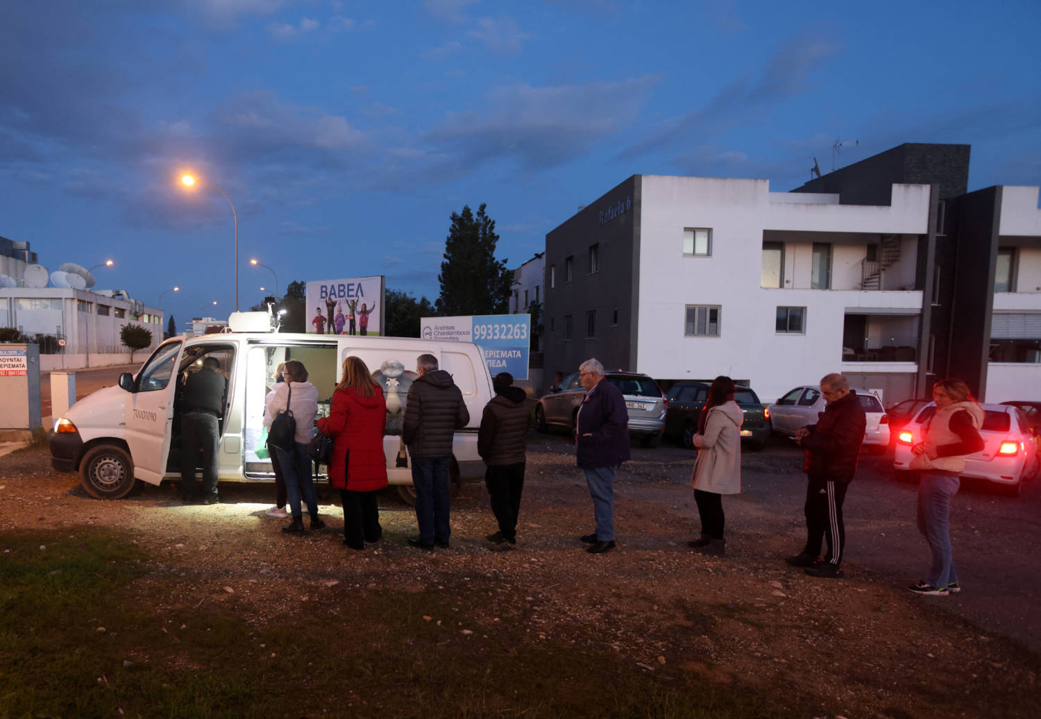 People Wait In Line To Buy Products From Pantelis Panteli's Van In Nicosia