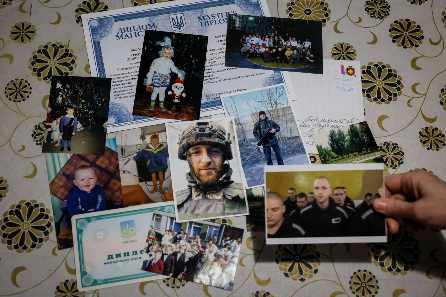 Pictures Of Ukrainian Serviceman, Currently A Pow, Is Seen On A Table In His Family House, In Dnipropetrovsk Region