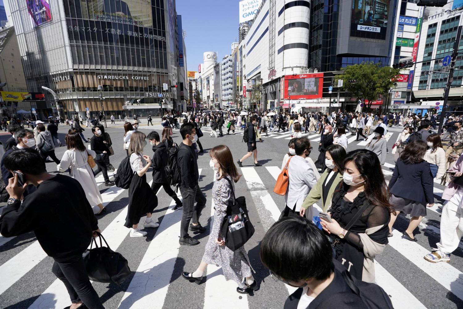 File Photo: Passersby Wearing Protective Face Masks Walk On Shibuya Crossing Amid The Coronavirus Disease (covid 19) Outbreak In Tokyo