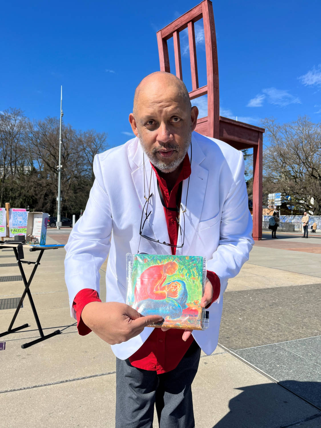Bruno Donat Holds Up A Painting By A Gazan Artist During A Hunger Strike For Children Affected During The Conflict Between Israel And Hamas, In Geneva