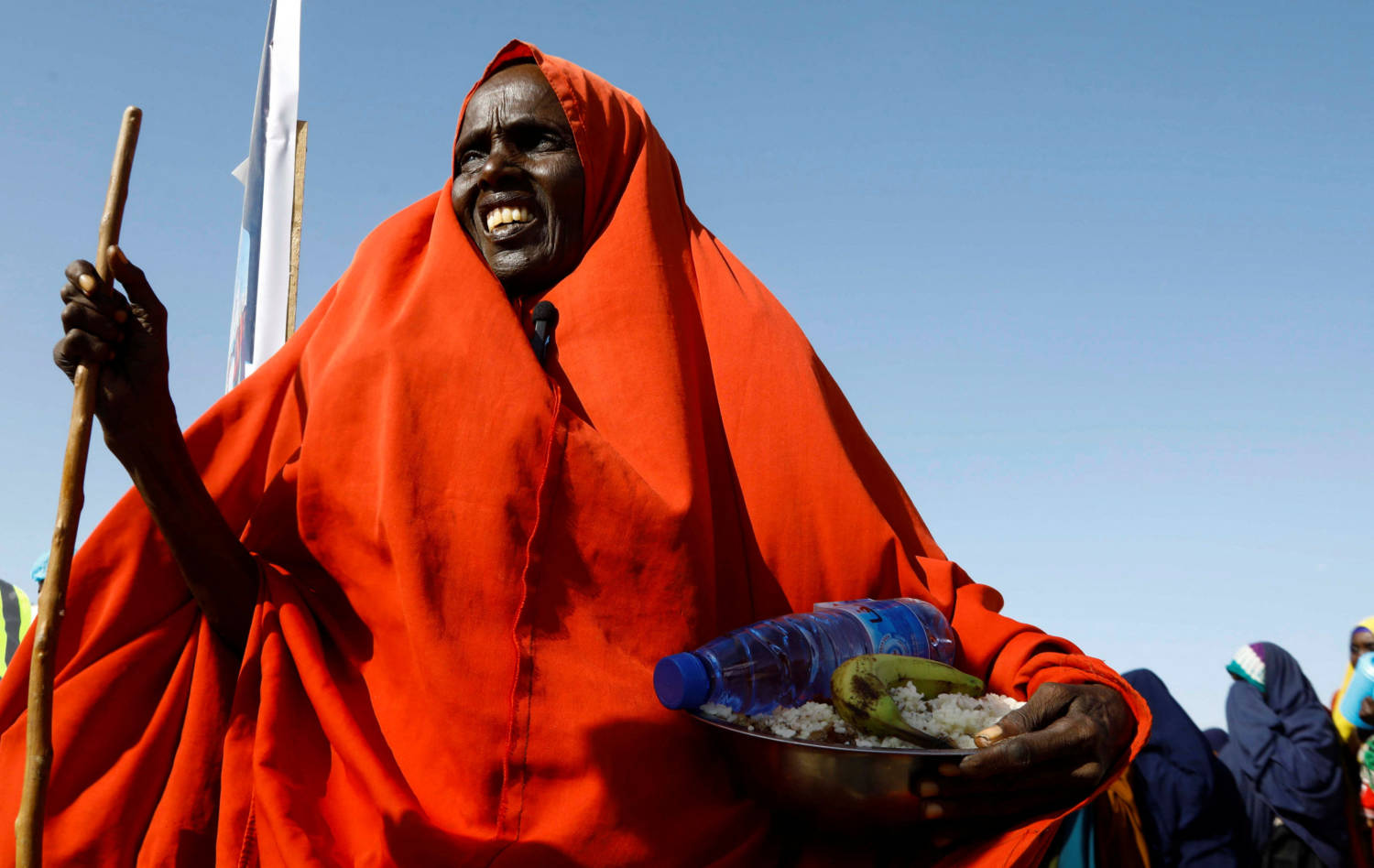 An Internally Displaced Somali Woman Walks After Receiving Iftar Food Rations For Ramadan, In The Outskirt Of Mogadishu