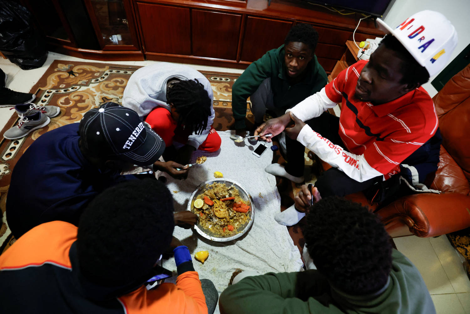 Former Senegalese Fishermen Khalifa Ndou And Momar Pouye Ngom Have Dinner Together With Companions