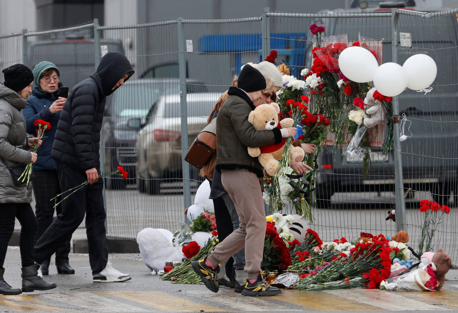 People Lay Flowers At A Makeshift Memorial To The Victims Of A Shooting Attack At A Concert Hall Outside Moscow