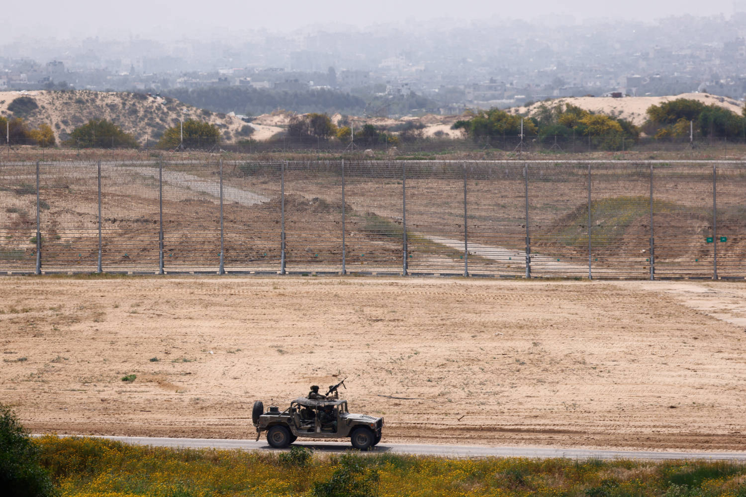 Israeli Soldiers Ride In A Military Jeep Along The Israel Gaza Border