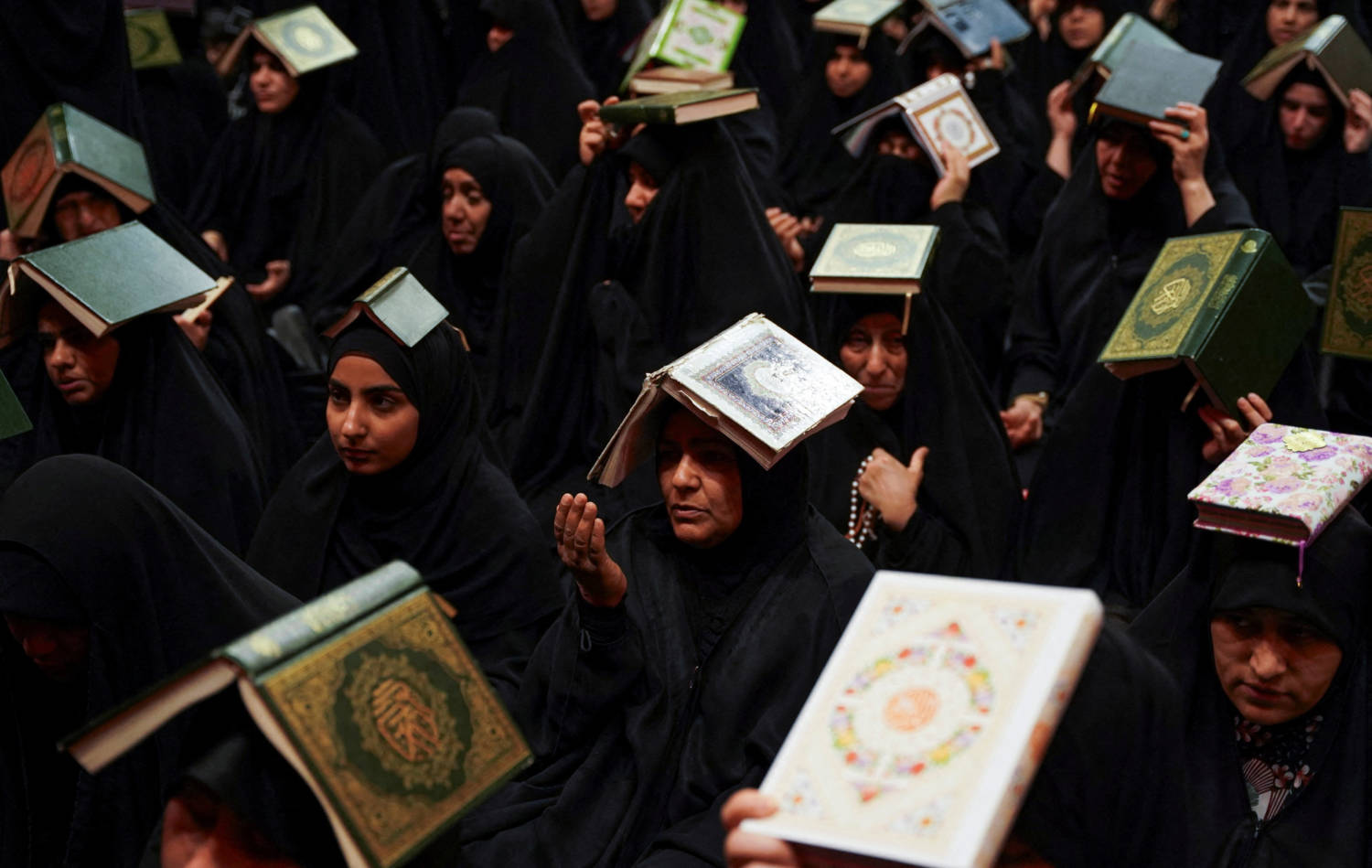 Shi'ite Worshippers Place Copies Of The Koran On Their Heads, During The Holy Month Of Ramadan At Imam Ali Shrine, In Najaf