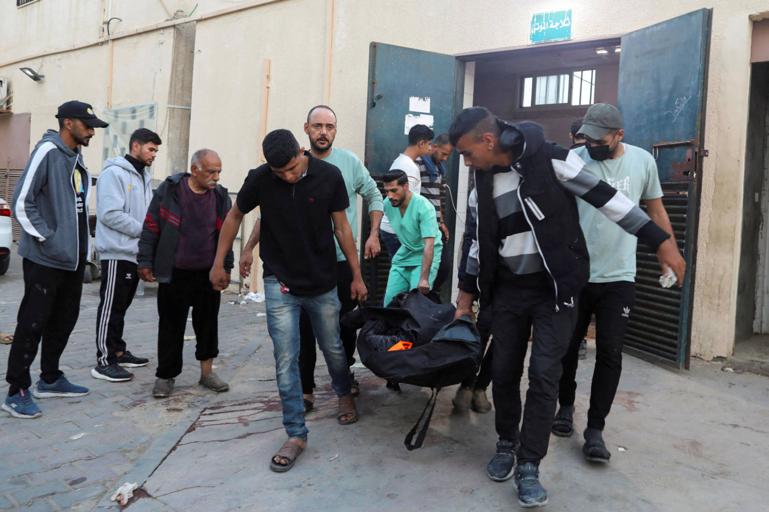 Palestinians Carry The Body Of A Foreign Employee From Wck At A Hospital In Deir Al Balah