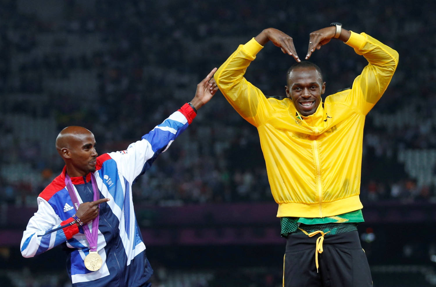 File Photo: Jamaica's Bolt Celebrates With Britain's Farah On The Podium After Each Receiving Gold Medals, Bolt For Men's 4x100m Relay And Farah For Men's 5000m At The Victory Ceremony At The London 2012 Olympic Games