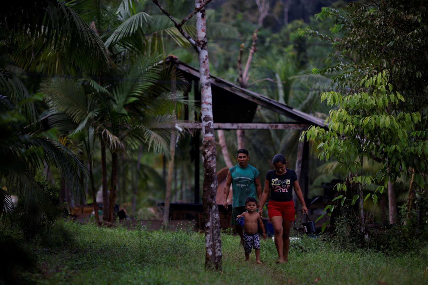 Eduardo Dos Santos, Atiele Santos And A Child Of The Karipuna Indigenous People Walk At The Ahuma Village, Near The Mouth Of The Amazon In Oiapoque