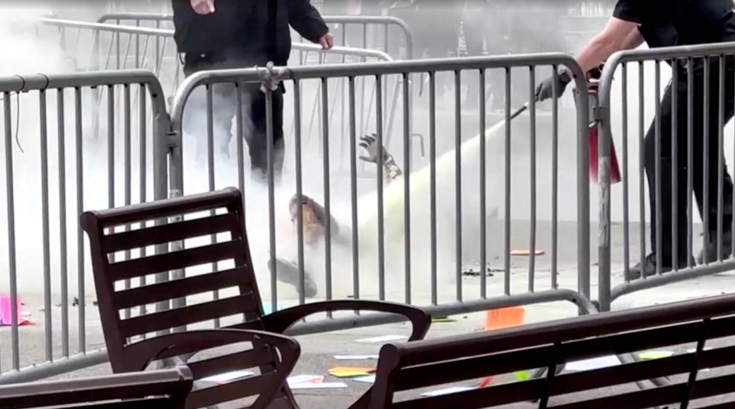 A Police Officer Uses A Fire Extinguisher On A Person Who Set Himself On Fire Outside The Courthouse Where Former U.s. President Donald Trump's Criminal Hush Money Trial Is Underway,