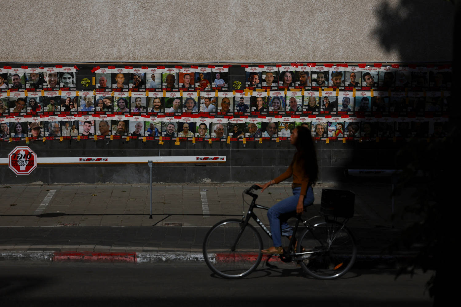 People Walk Past Posters Of Hostages Kidnapped In The October 7 Attack By Hamas, In Tel Aviv