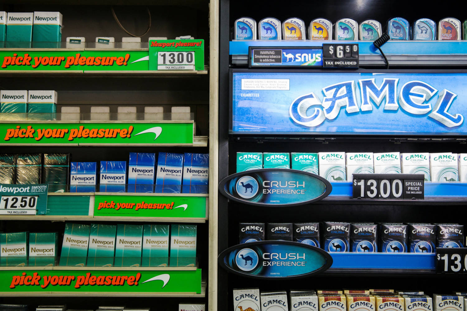 File Photo: Newport And Camel Cigarettes Are Stacked On A Shelf Inside A Tobacco Store In New York