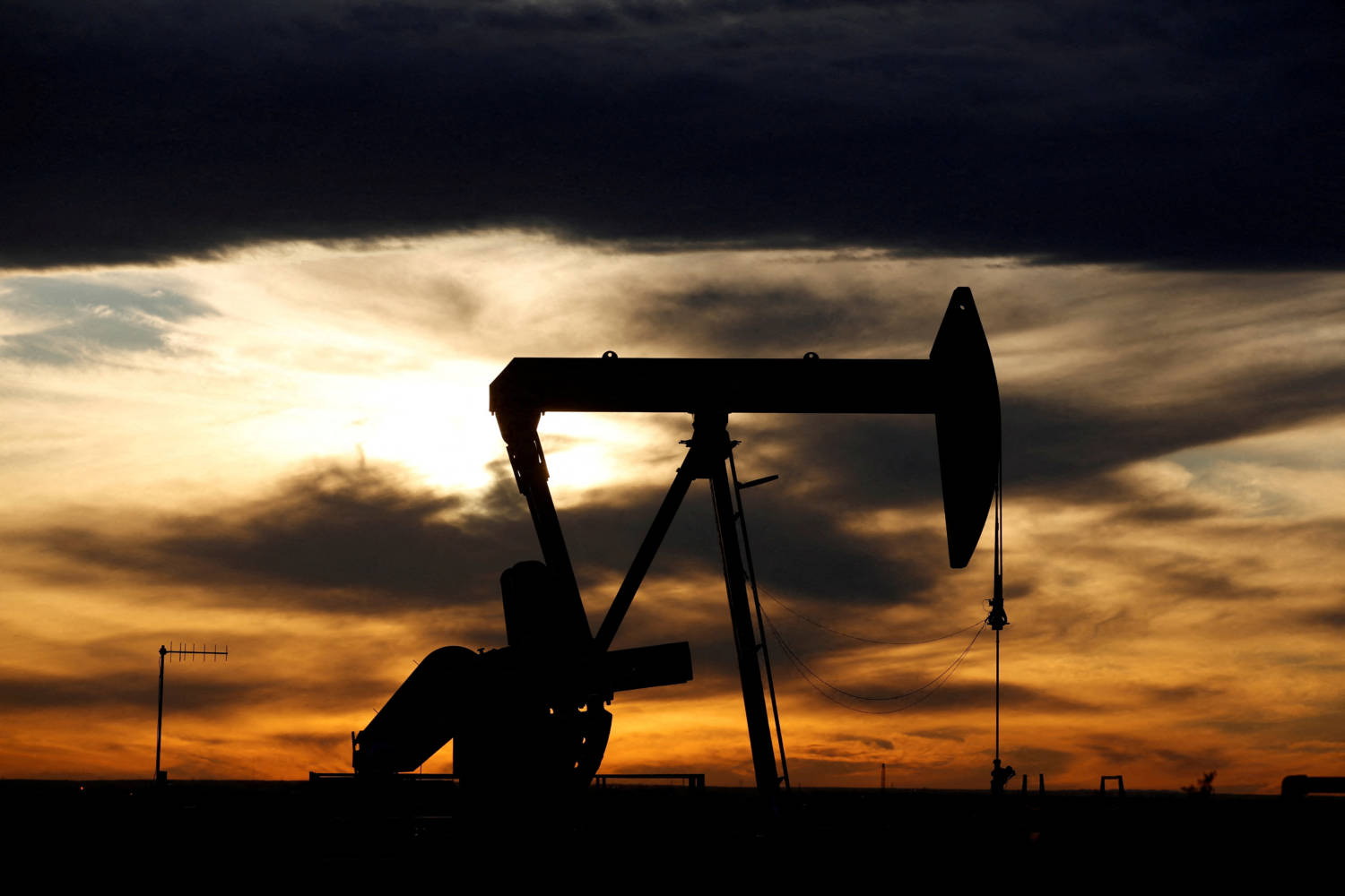 File Photo: The Sun Sets Behind A Crude Oil Pump Jack On A Drill Pad In The Permian Basin In Texas
