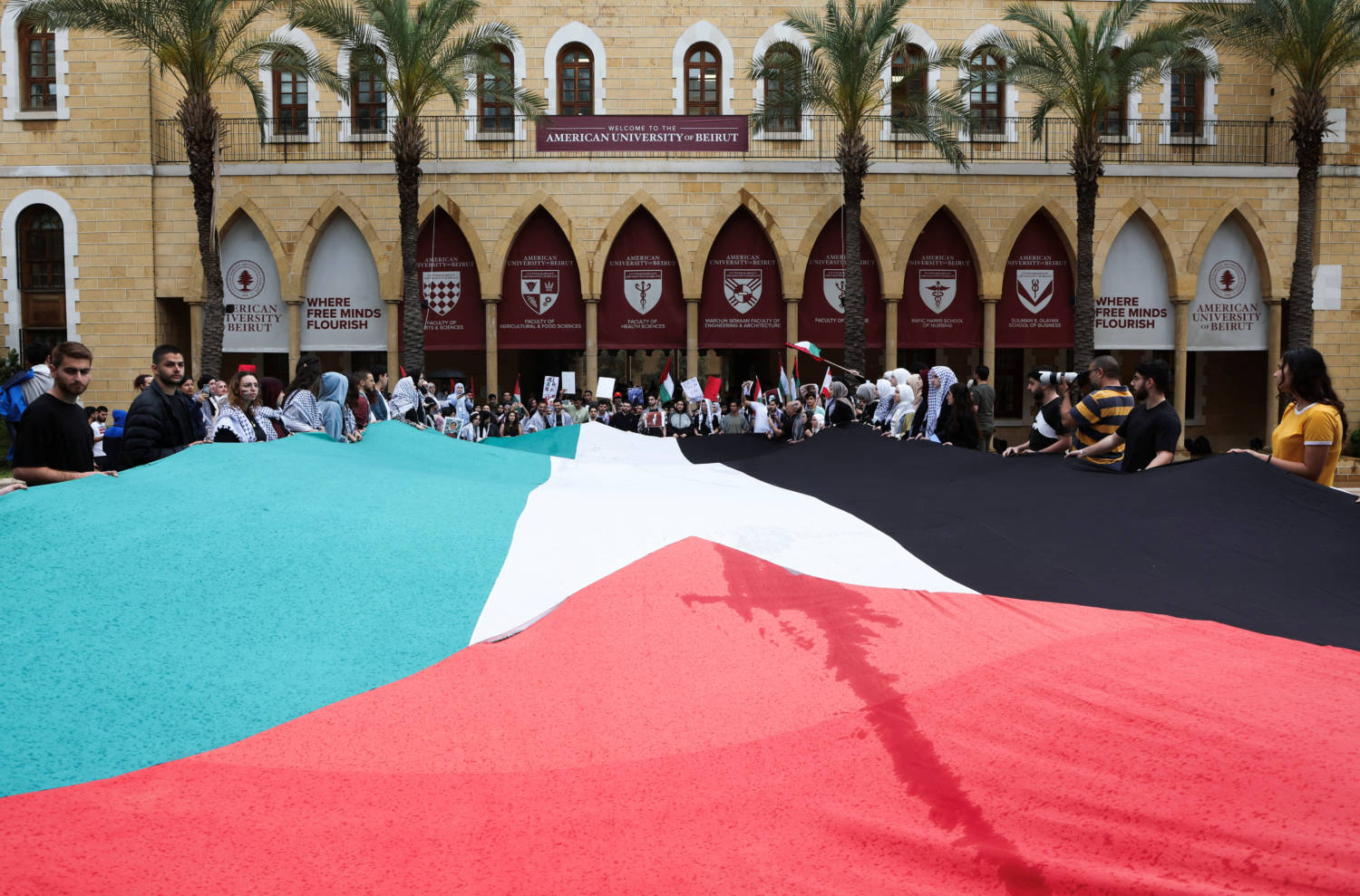 Demonstrators Hold A Palestinian Flag During A Protest In Solidarity With Gaza At The American University Of Beirut