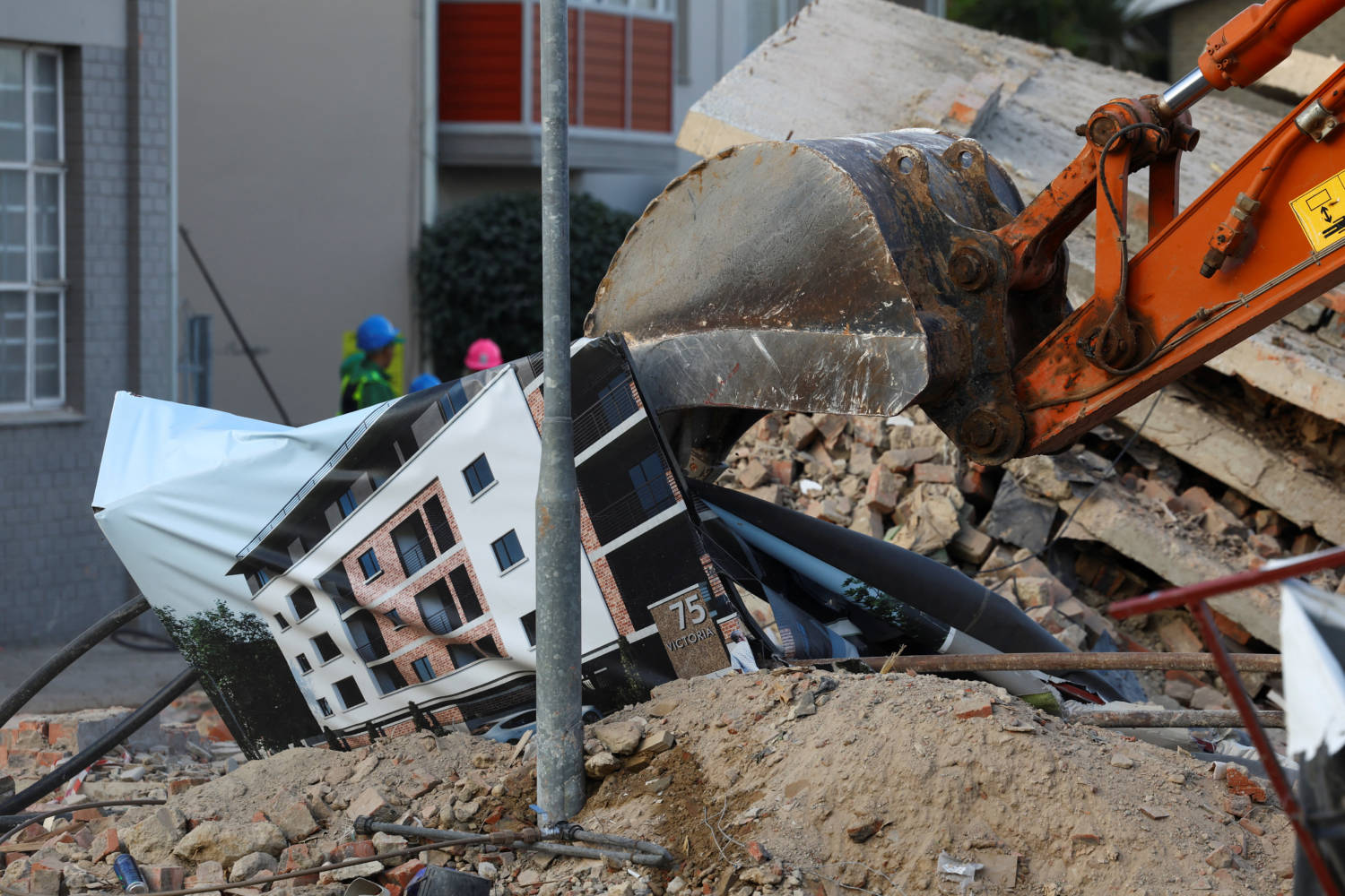 Rescuers Work To Rescue Construction Workers Trapped Under A Building That Collapsed In George